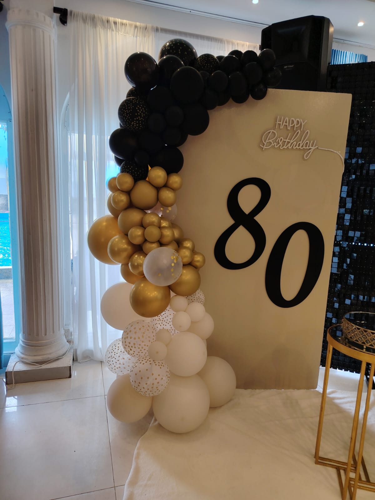 Elegant 80th birthday balloon backdrop with metallic colors