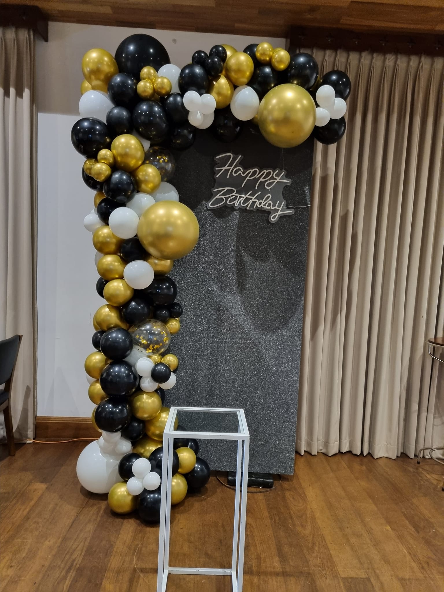 Custom event backdrop decoration with balloons and floral elements