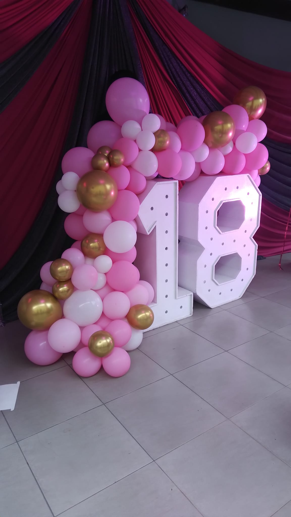 18th birthday balloon decoration setup with large number balloons
